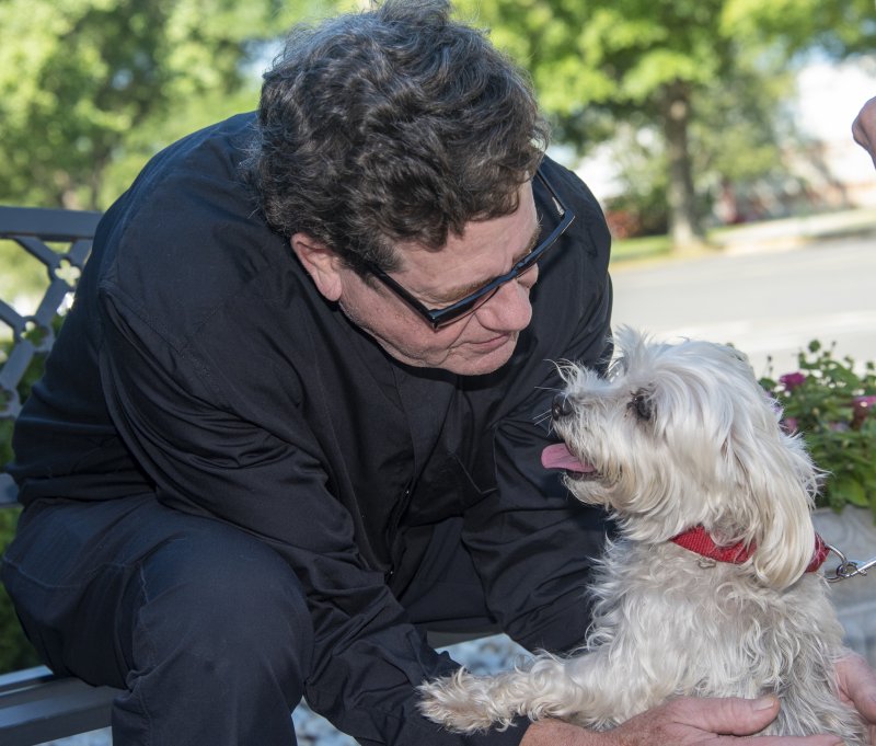 Pastor Tad Thayer offers love and a blessing for Marcia Pokorski’s sweet dog, Gidget. DENY HOWETH PHOTOS